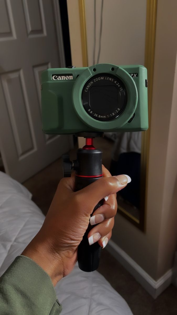 a woman holding a camera in her hand