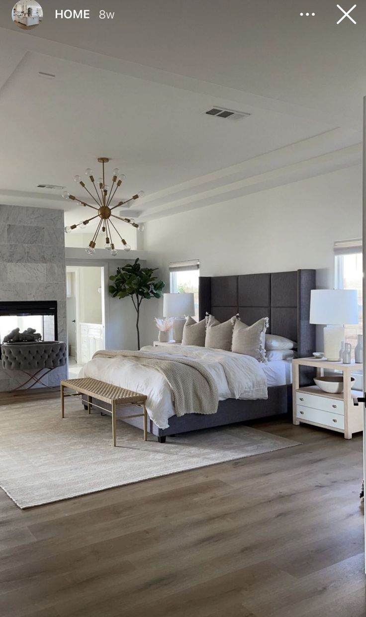 a bedroom with a large bed and fireplace in it