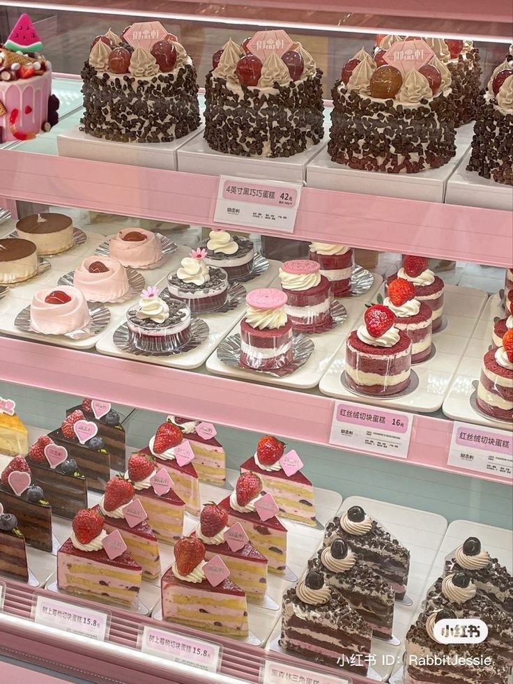 a display case filled with lots of different types of cakes and desserts on top of shelves