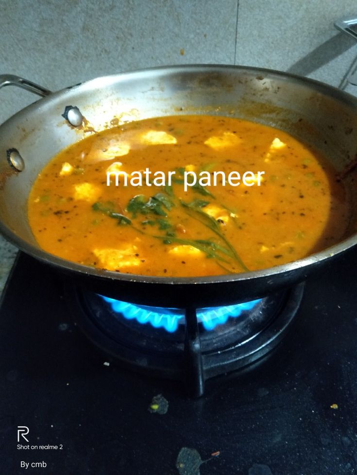 a metal pan filled with food on top of a stove