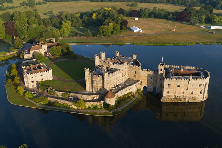 an aerial view of a castle on the water