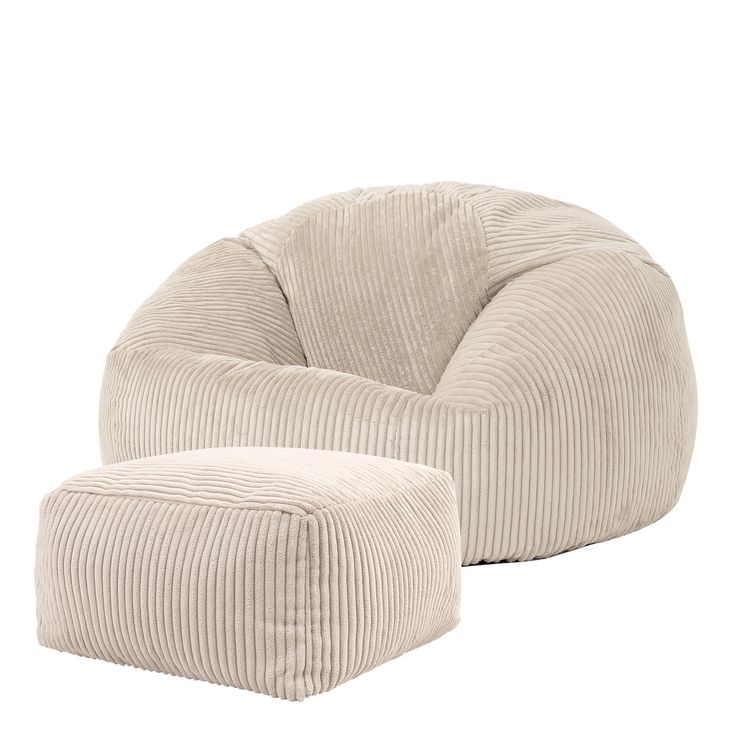 a white chair and ottoman sitting on top of a white floor next to each other