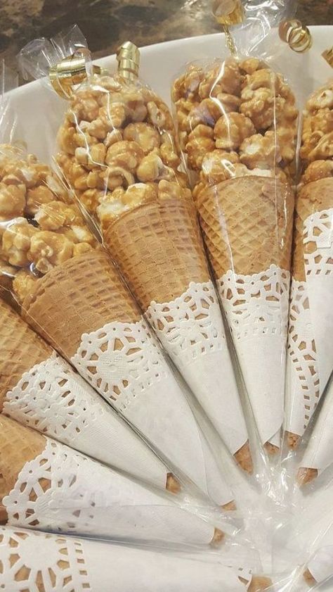 ice cream cones with nuts in them on a table