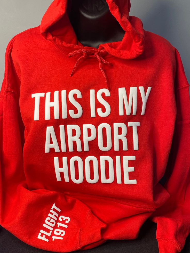 "ntroducing the perfect companion for your travels - the \"This Is My Airport Hoodie\". Upgrade your travel wardrobe and make a statement wherever you go with the \"This Is My Airport Hoodie\". Order yours today and embark on your next adventure in style. Features: Premium quality Red Hoodie Unisex Bold White 3D Puff \"This Is My Airport Hoodie\" Comfortable and soft fabric Versatile design for travel or casual wear Cozy hood for extra warmth Available in multiple sizes for the perfect fit" Delta Sigma Theta Shirts, J13 Delta Sigma Theta Outfit, Delta Sigma Theta Denim Jacket, Delta Sigma Theta Poncho, Delta Sigma Theta Line Jackets, Delta Sigma Theta Jersey, Delta Sigma Theta Apparel, Delta Sigma Theta Gifts, Delta Sigma Theta Sweatshirts & Hoodies