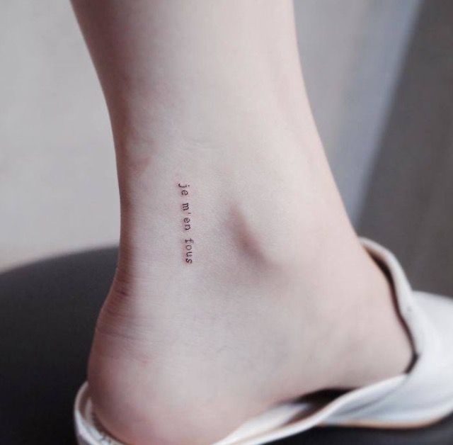 a person with a small tattoo on their foot that reads, i love my tattoos