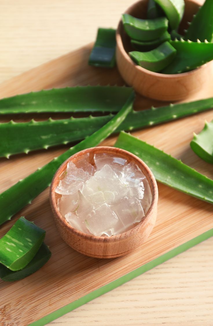 aloeni and sugar in wooden bowl on cutting board next to sliced aloeni