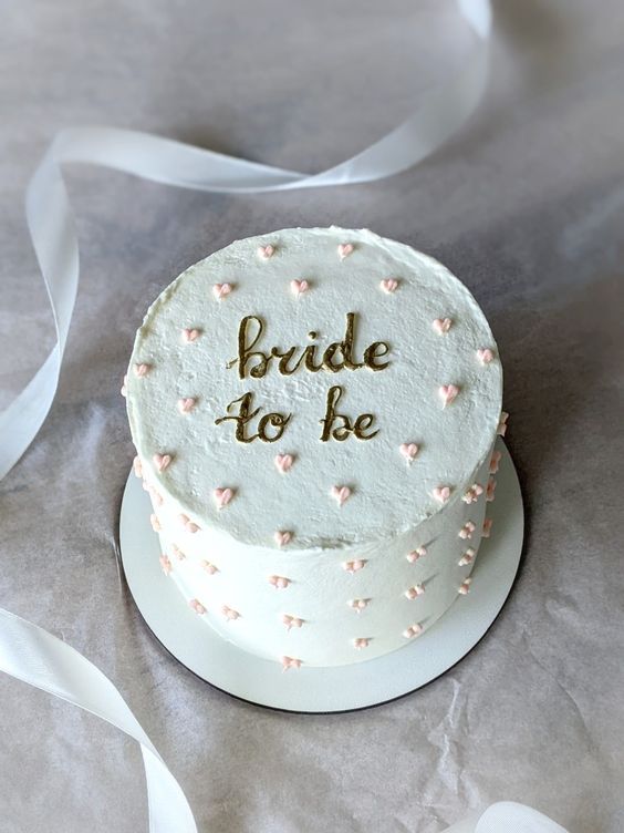 a wedding cake with the words bride to be written on it and white frosting