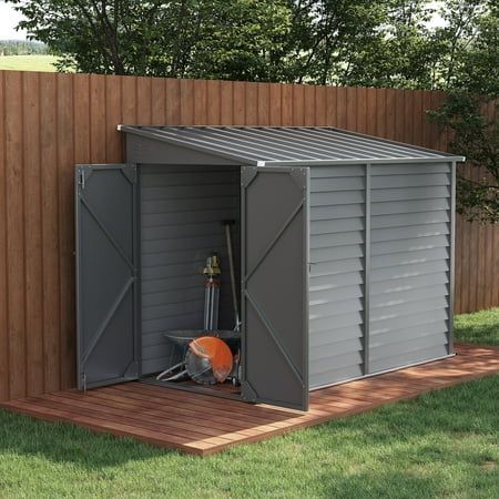 a metal shed sitting on top of a wooden deck