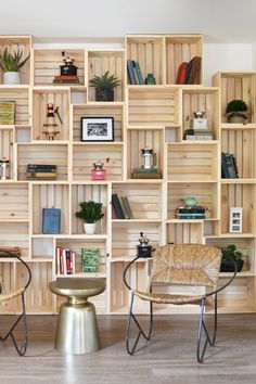 a living room filled with lots of wooden shelves