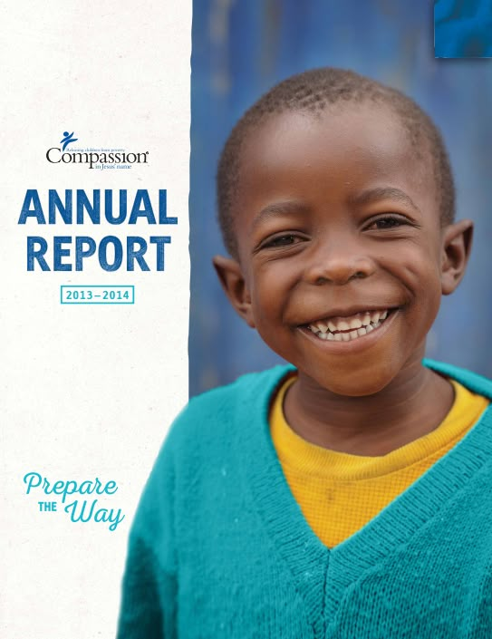 a young boy smiles for the camera in front of a sign that says annual report 2013 - 2013