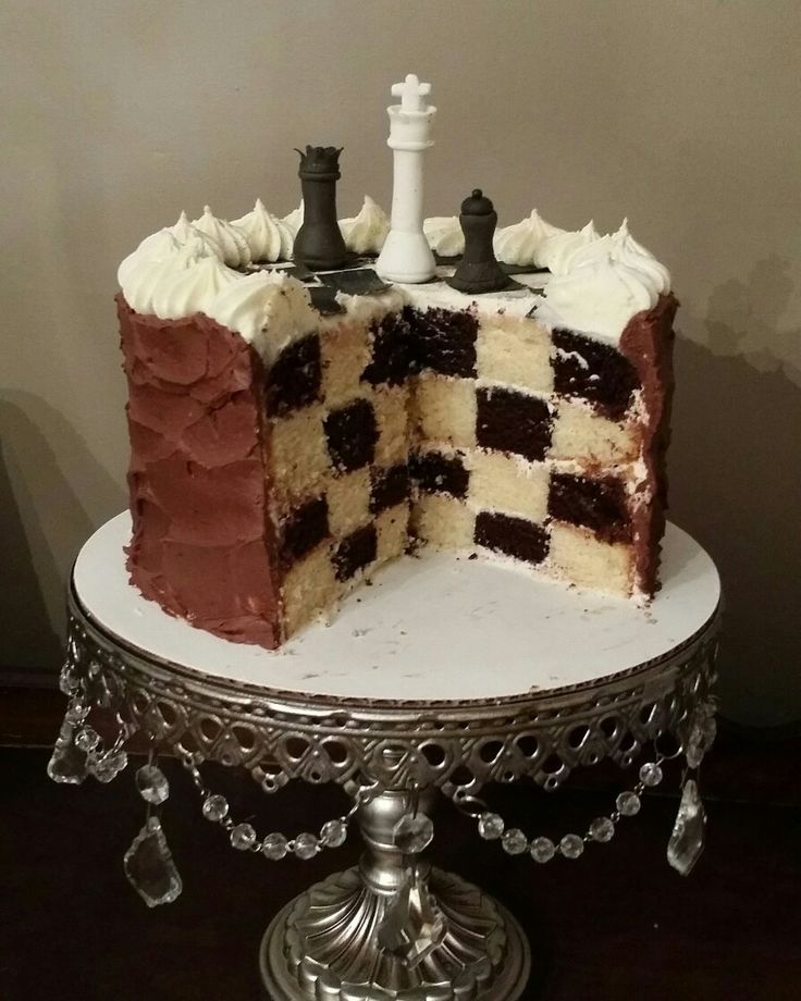 a cake that is sitting on top of a table with a chess piece cut out of it