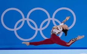 a woman in red and white jumps into the air