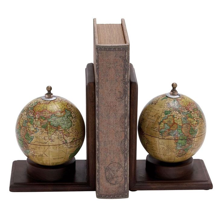 an old book with two globes sitting on it's sides next to each other