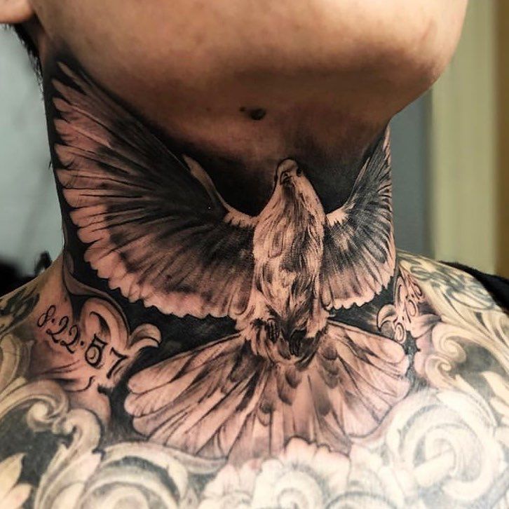 a man with a bird tattoo on his neck