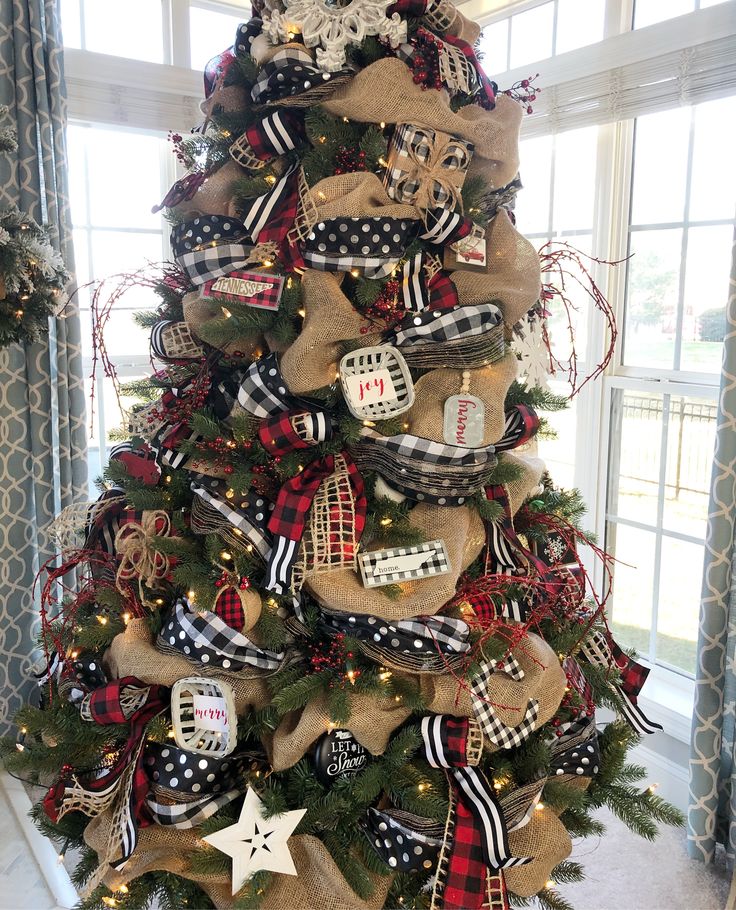 a christmas tree decorated with burlocks and ribbons