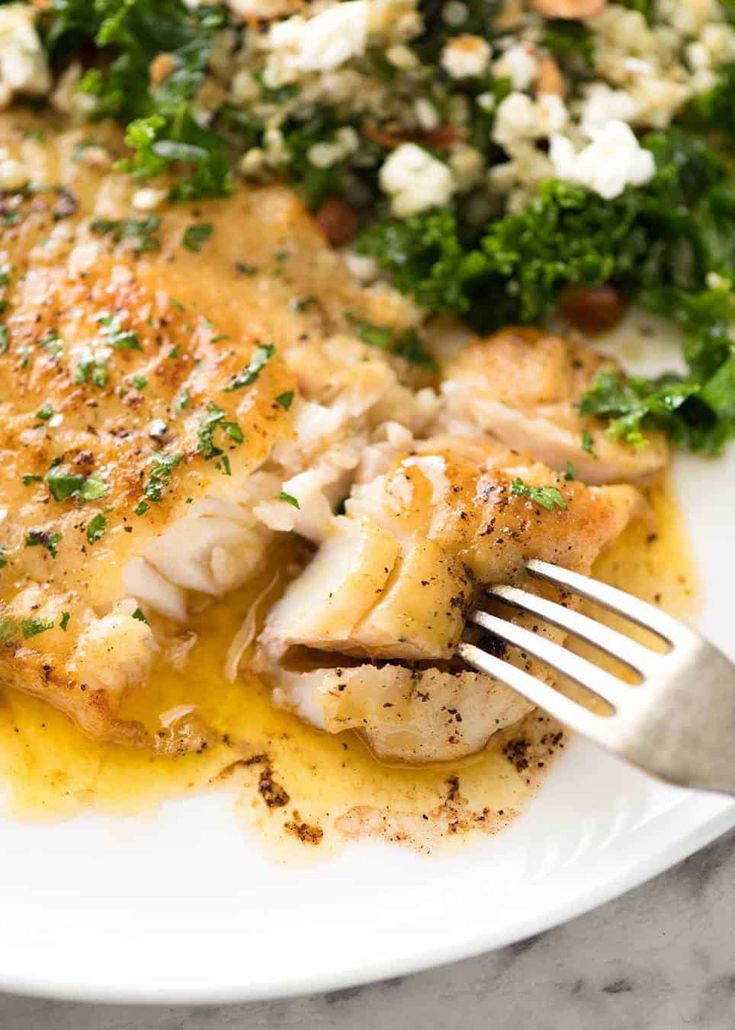 a close up of a plate of food with broccoli and chicken on it