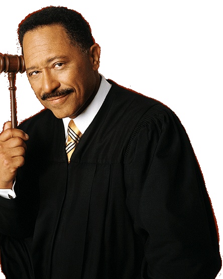 a man holding a wooden judge's gavel in his right hand and looking at the camera