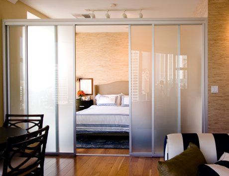 a bedroom with sliding glass doors leading to a bed