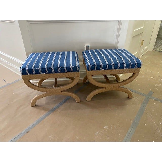 two blue and white striped stools sitting on the floor in front of a door