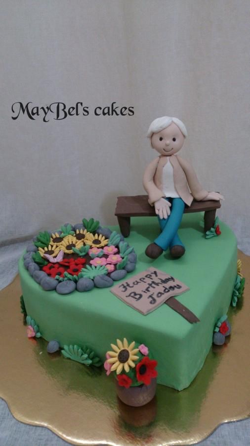 a cake with a person sitting on a bench