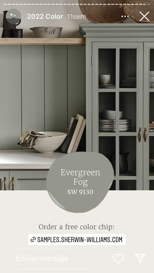 the green cabinets in this kitchen are painted with shelving - williams's evergreen paint