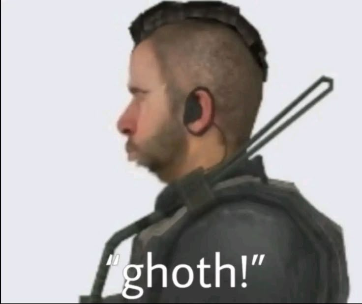 the man is wearing ear buds and looking at something in his hand that says, ghoth