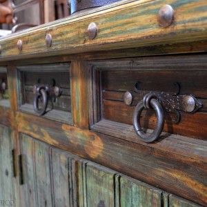 an old wooden cabinet with metal handles and knobs