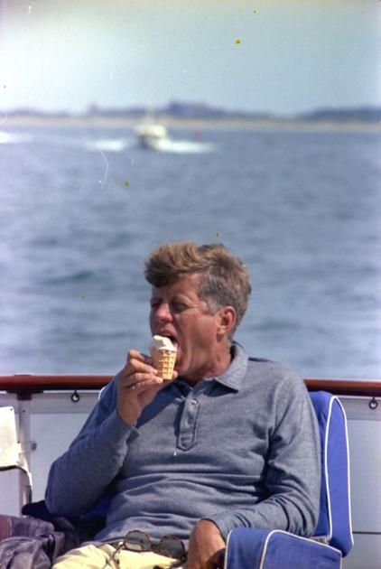 an older man eating ice cream on a boat