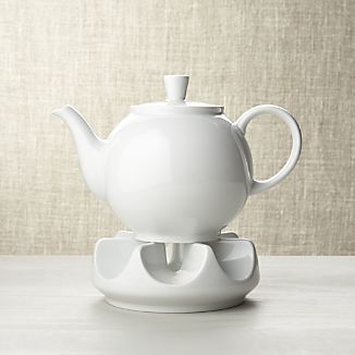 a white tea pot sitting on top of a saucer