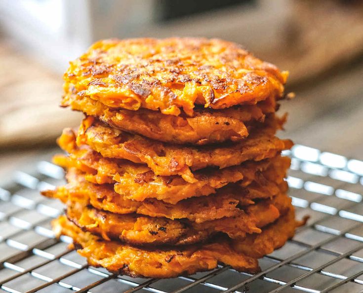 a stack of sweet potato pancakes on a cooling rack