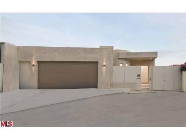 a house with a driveway and garage in front of it