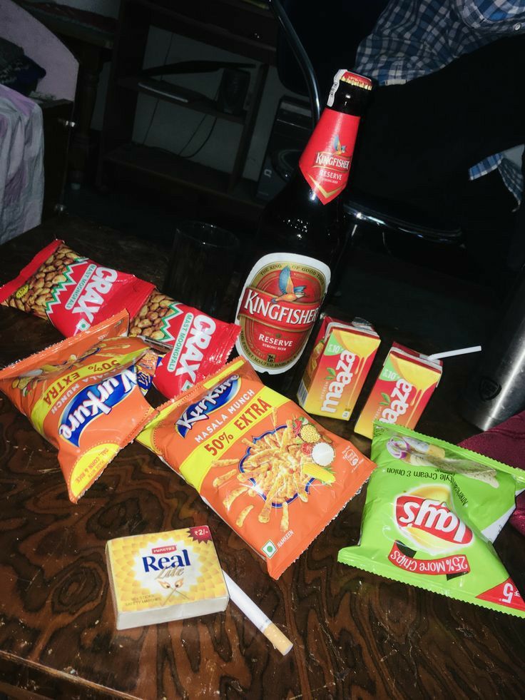 various snacks are laid out on a table next to a bottle of soda and a bag of chips