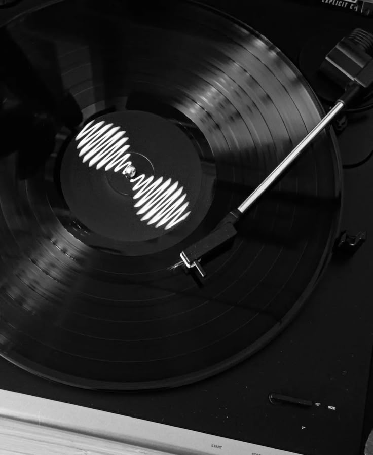 an old record player with its turntable turned upside down and the vinyl on it's side