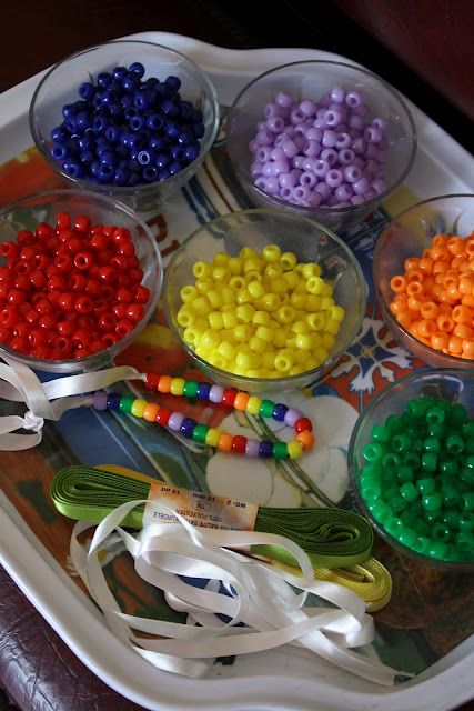 there are many beads in bowls on the tray