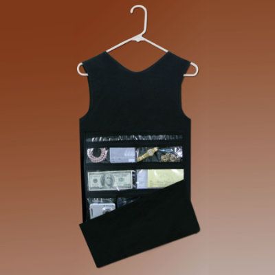 a black tank top hanging on a hanger with money in the pocket and other items inside it