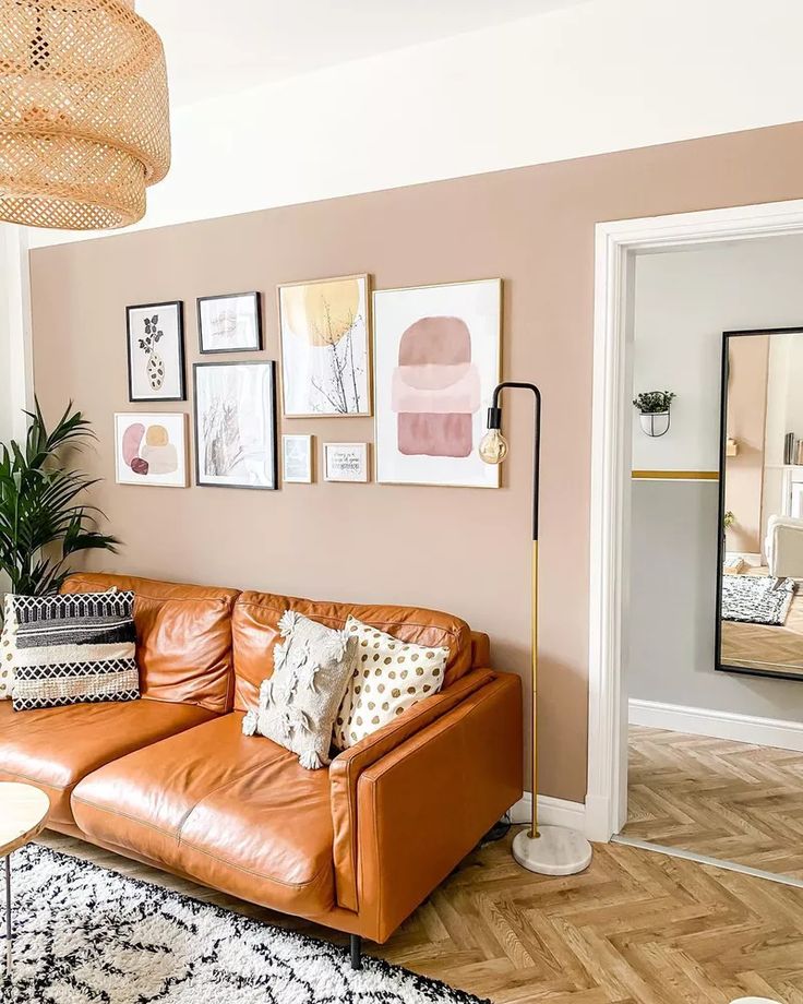 a living room filled with furniture and pictures on the wall above it's couch