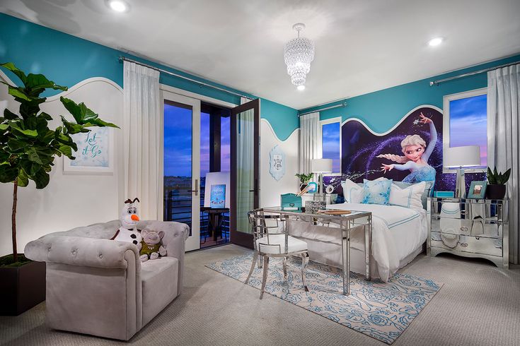 a bedroom decorated in blue and white with a disney princess poster on the wall