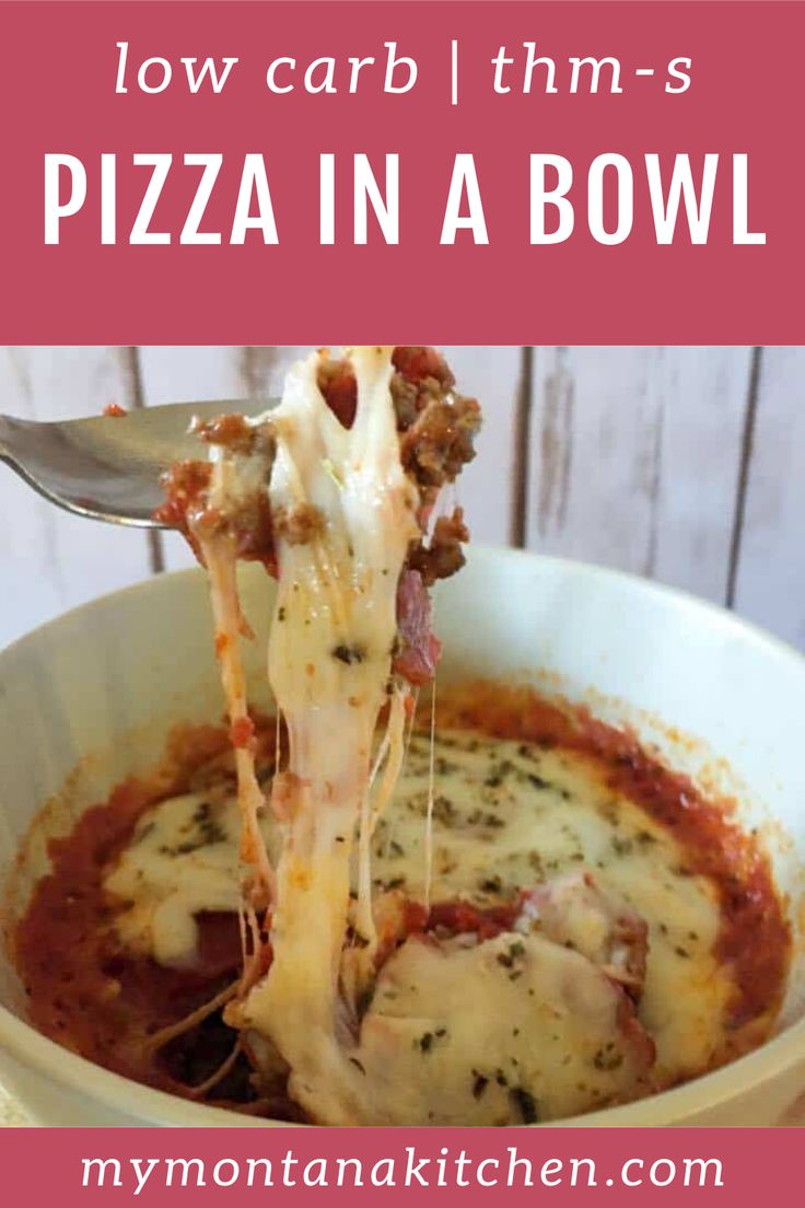 a white bowl filled with lasagna sauce and cheese being held up by a fork