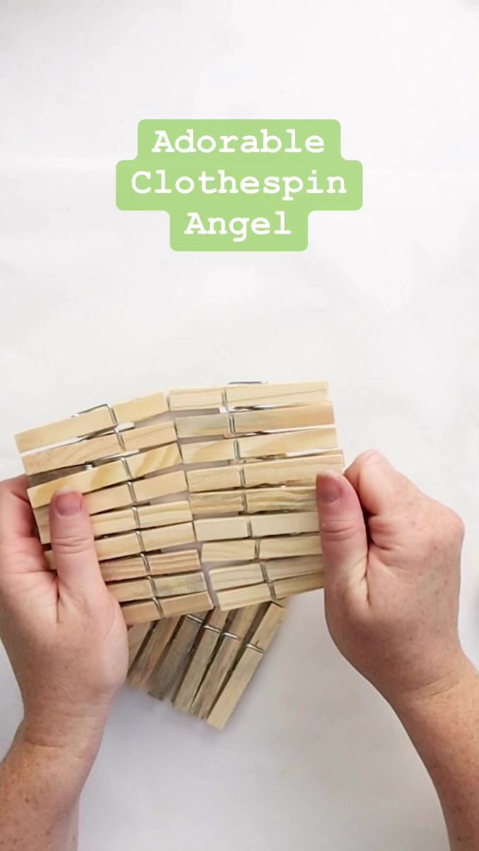 two hands are holding wooden clothespins against a white background with the words adorable clothespin angel above them