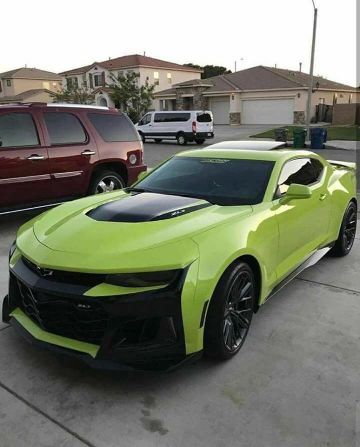 a bright green chevrolet camaro parked in a parking lot