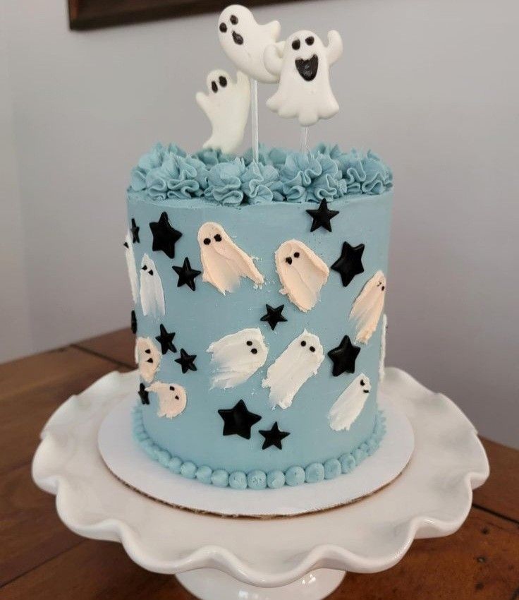 a blue cake decorated with ghost and stars