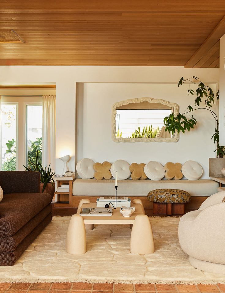 a living room filled with furniture and plants