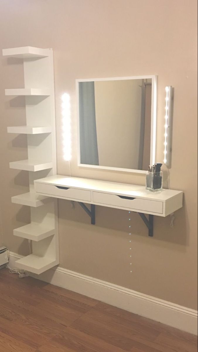 a white dressing table with lighted mirror and shelves