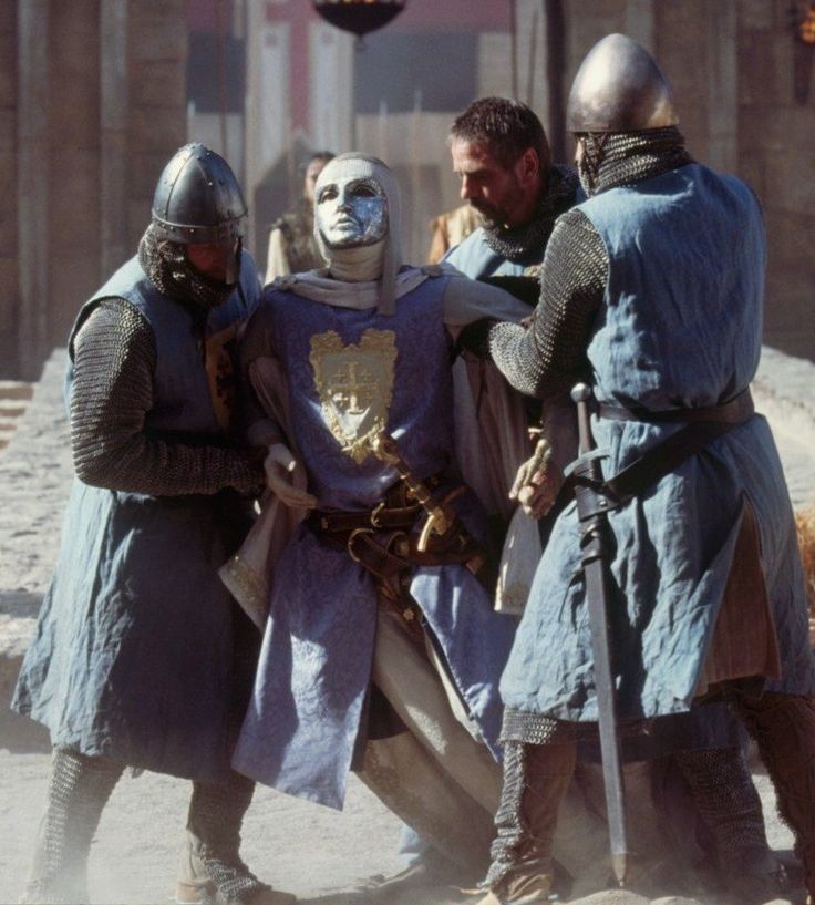 three men in medieval costumes standing next to each other