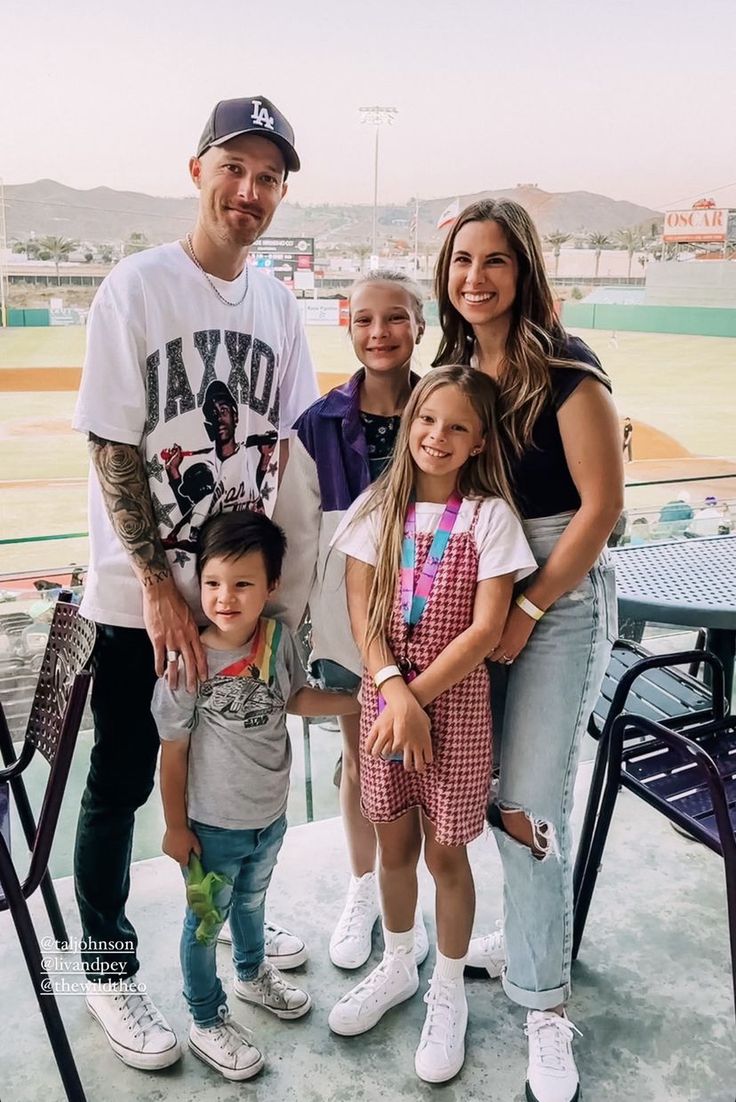 a family posing for a photo at a baseball game