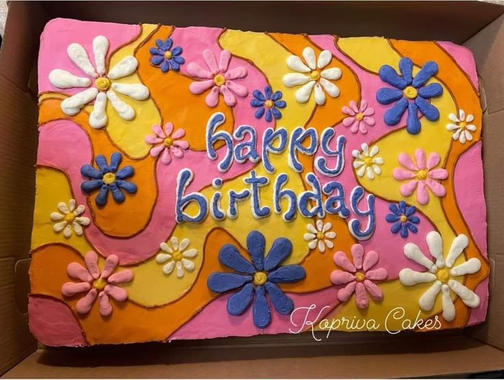 a birthday cake in a box with flowers on it