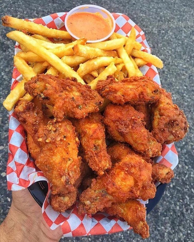 chicken wings and french fries on a plate with ketchup