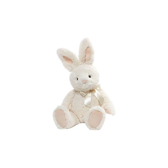 a white stuffed rabbit sitting up against a white background