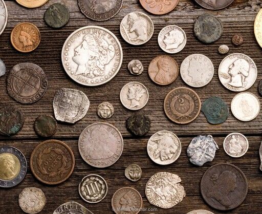 many different types of coins on a table