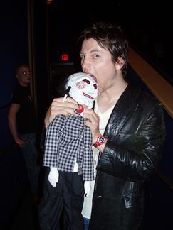 a man holding a stuffed animal in his hands